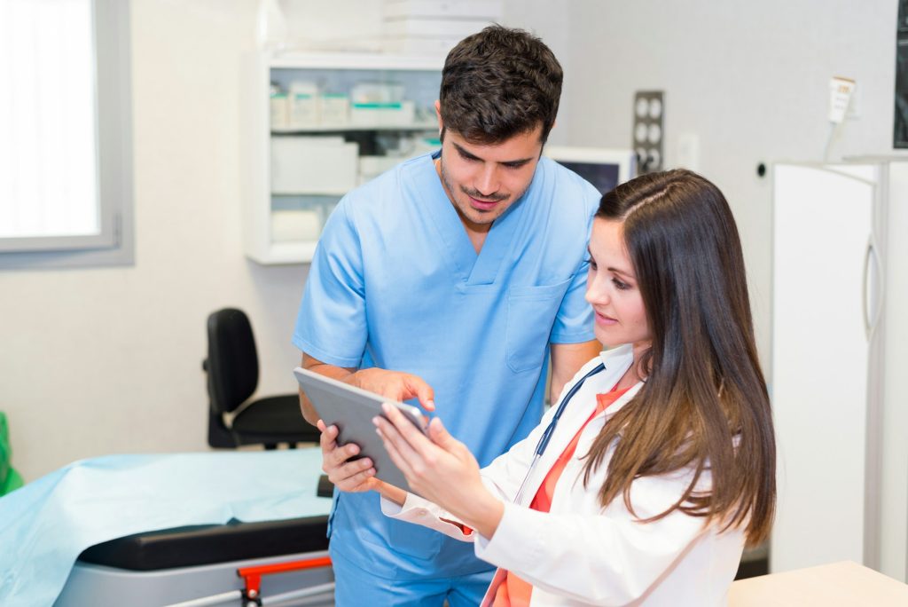 doctors working at hospital with tablet